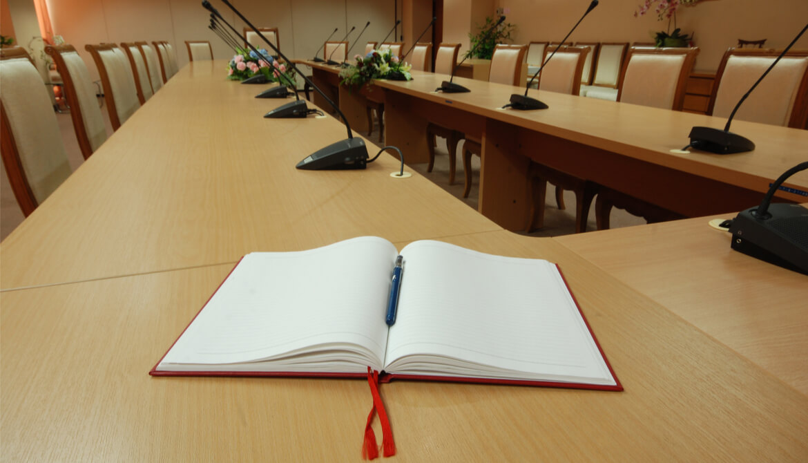 open notebook at a boardroom table