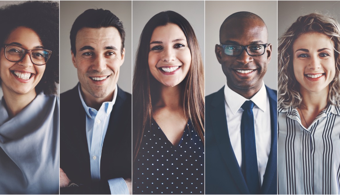 five smiling engaged people of diverse ethnic backgrounds