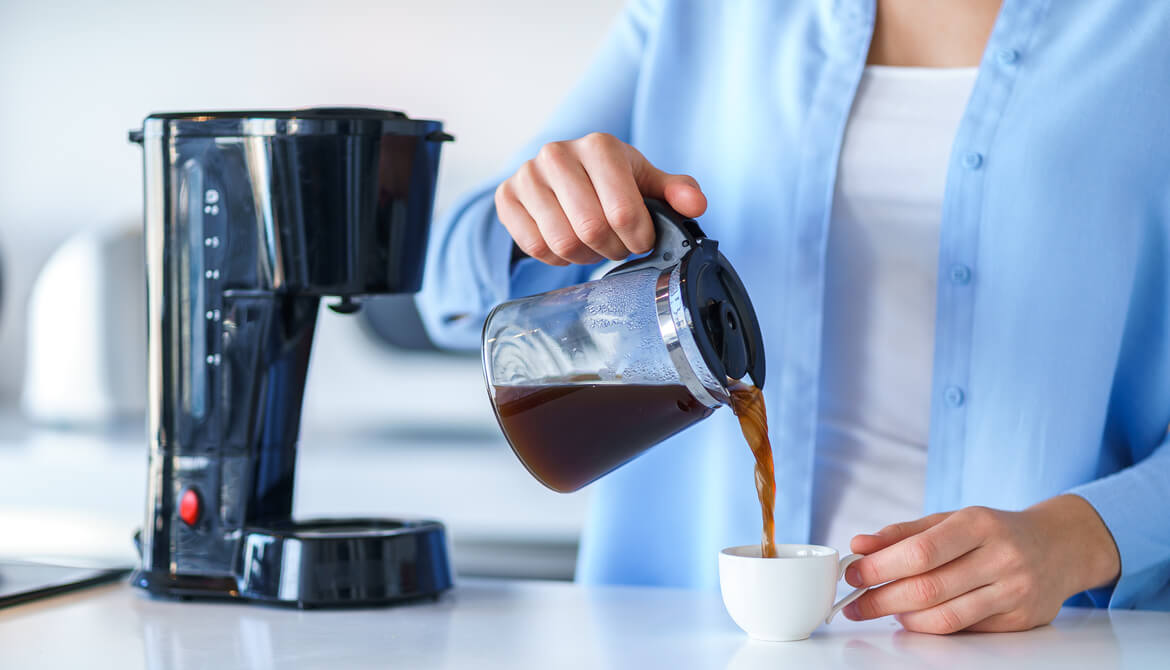 woman pouring morning coffee