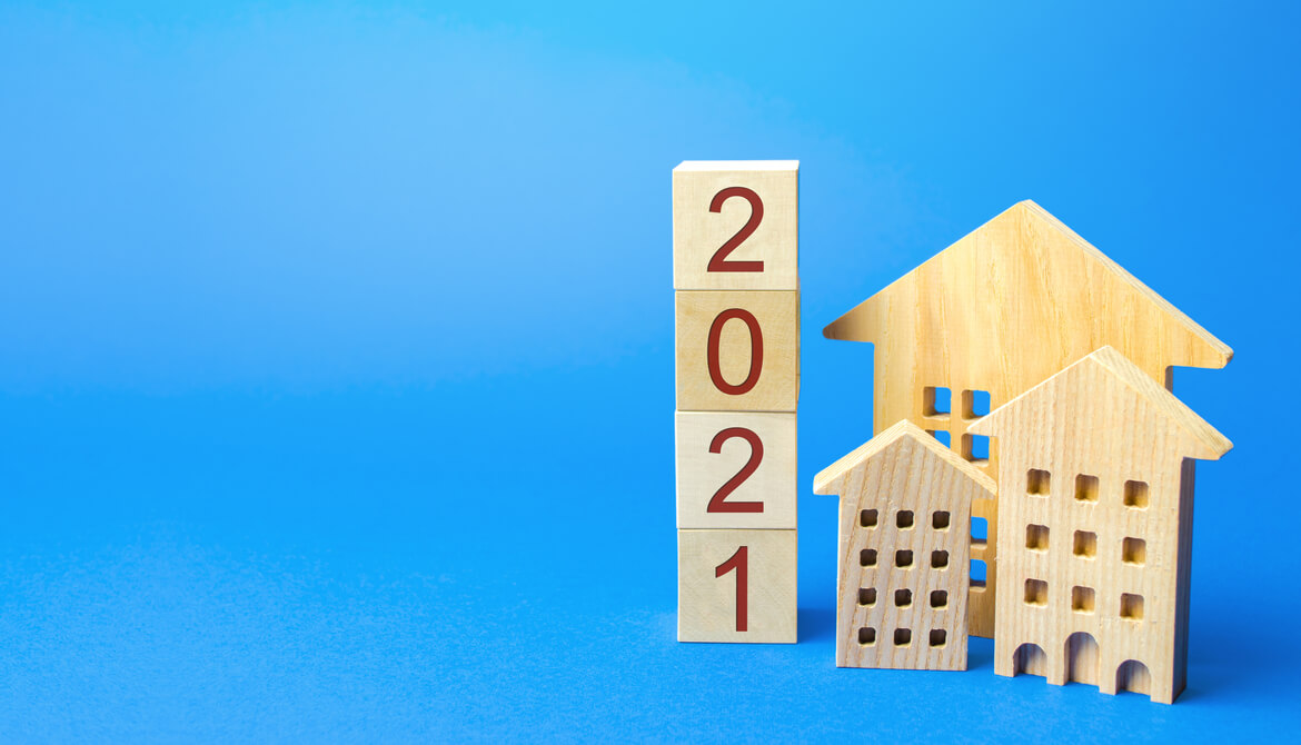 wooden blocks of houses and the year 2021