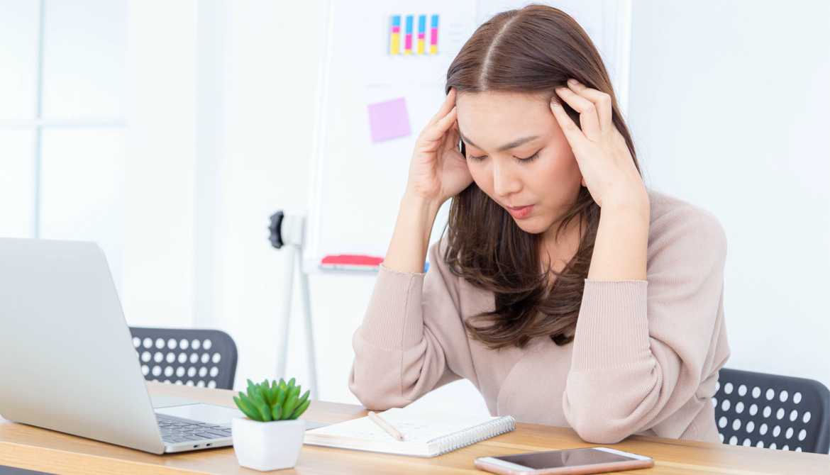 sian businesswoman having a headache