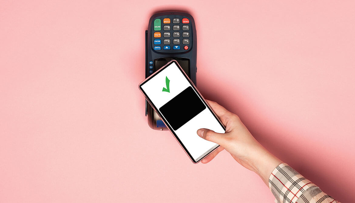 hand reaching out with smartphone to pay with digital wallet at contactless card reader