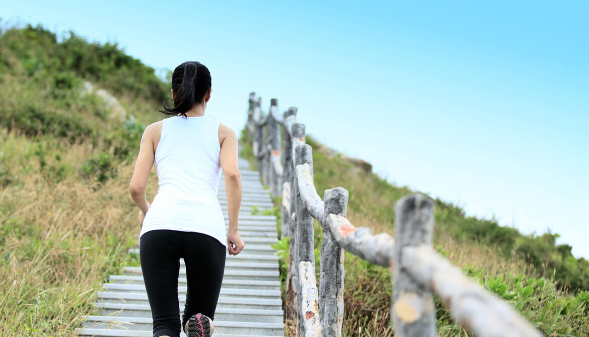 woman running on mountain stairs