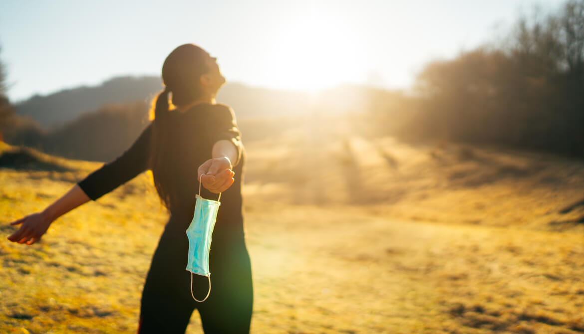 woman outdoors with mask off