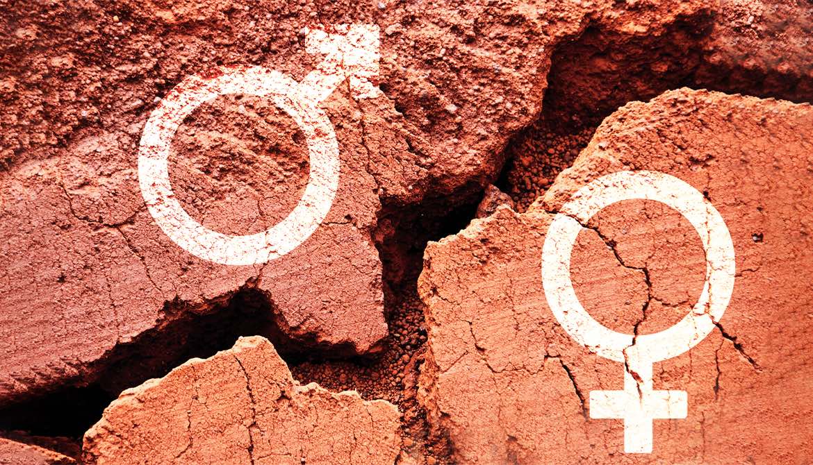 chalk symbols representing male and female gender on red clay earth on opposite sides of a chasm