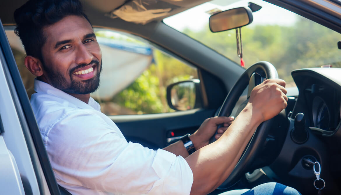 smiling man sitting in a car