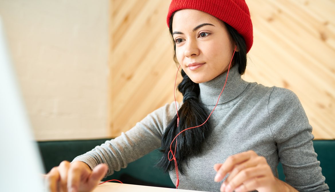 young woman red cap laptop