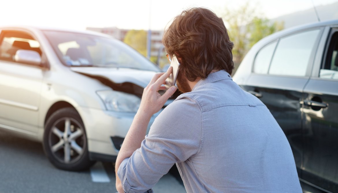 man making call on smartphone after an accident