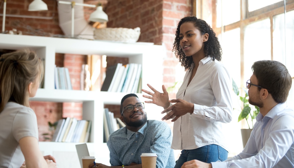 young Black businesswoman leading discussion with team