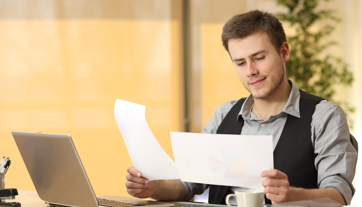 businessman thinking about and comparing two documents