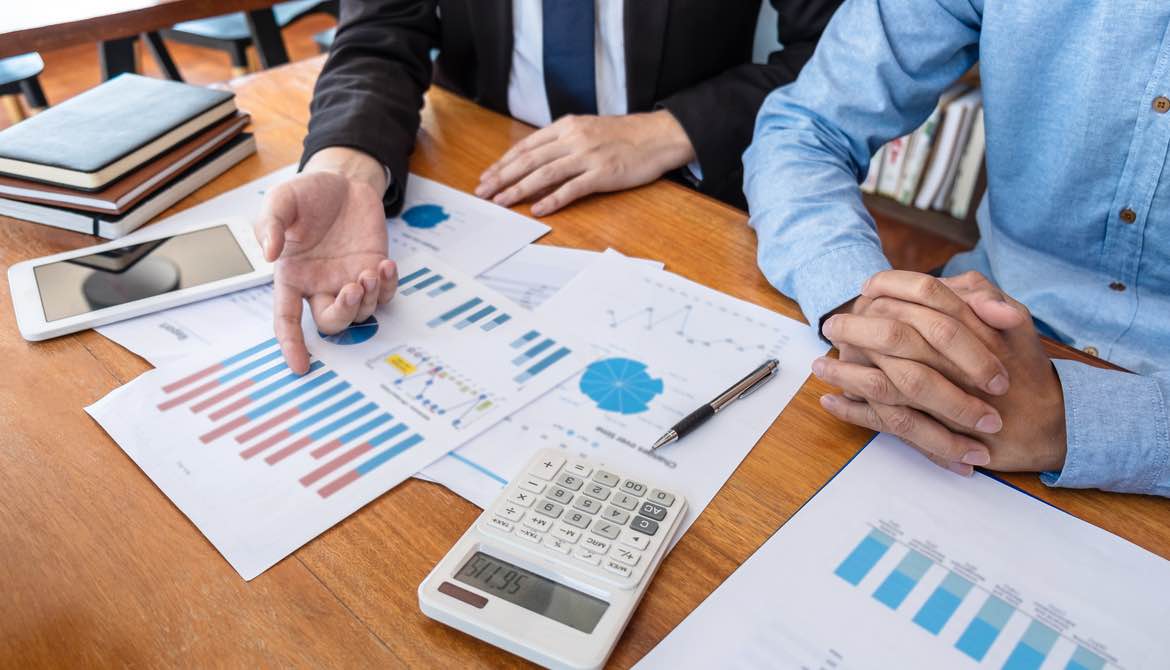 executives at a table doing financial planning