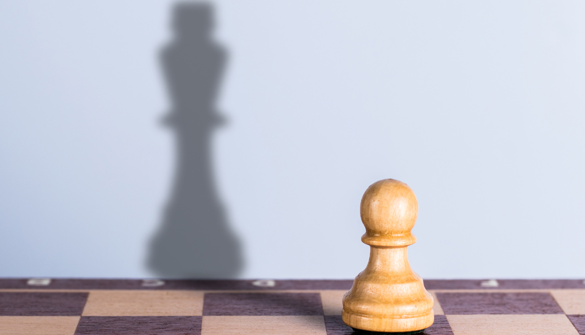 pawn with king shadow on chessboard