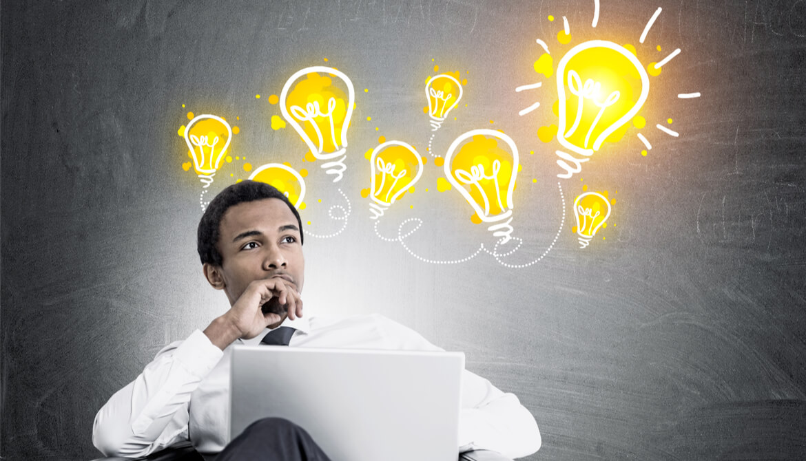 Black businessman sitting in a chair with light bulbs