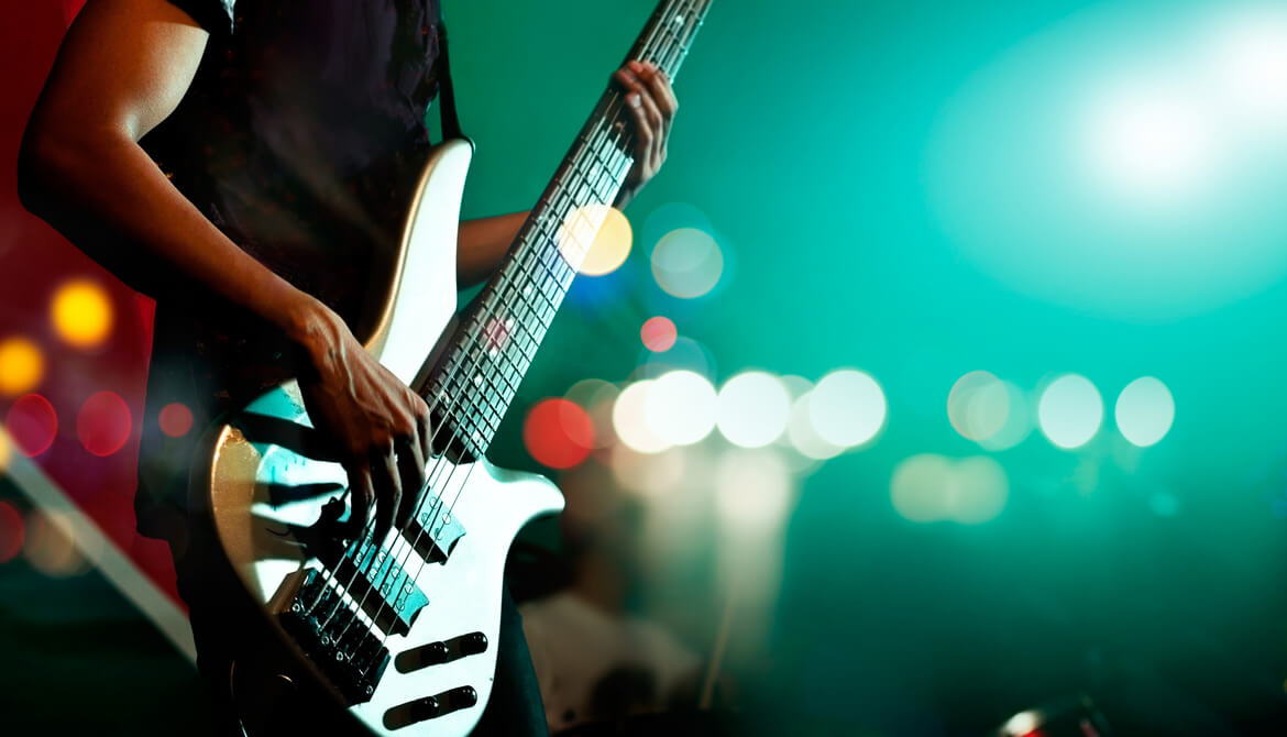 guitarist plays electric guitar in concert