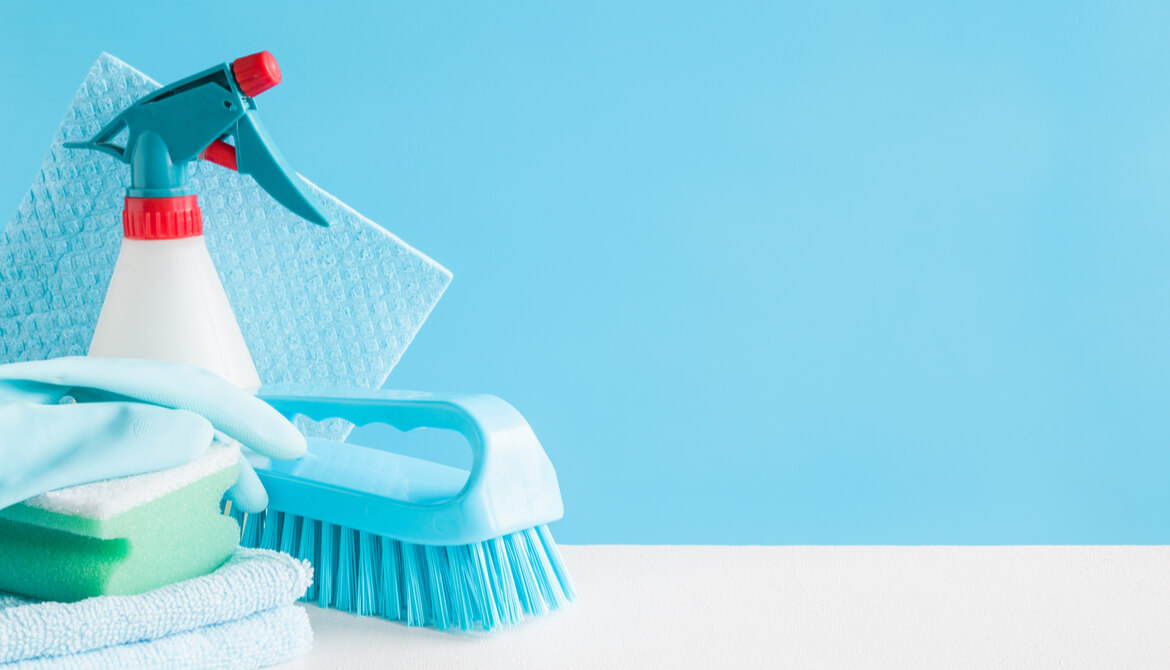 brightly colored cleaning supplies on a green background