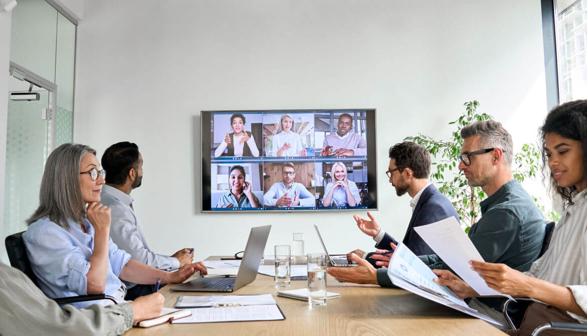 diverse board meeting with some people online and some in person