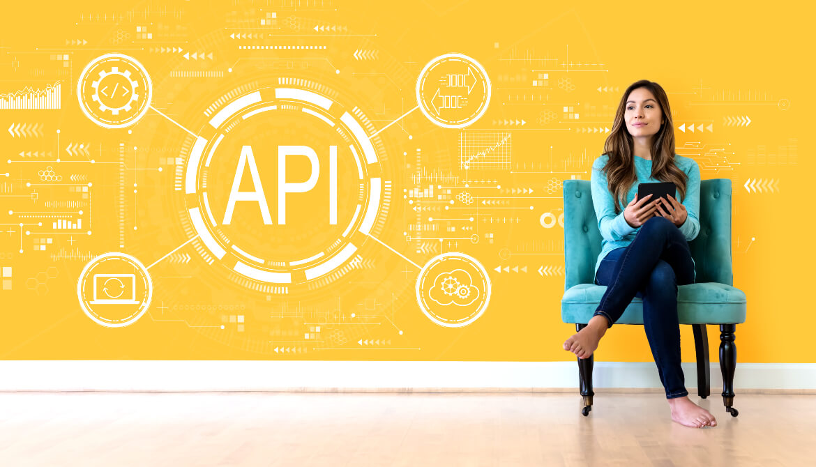 woman sitting in front of yellow background with API graphic