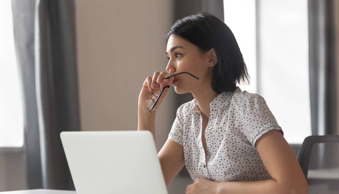 Asian executive thinking with laptop