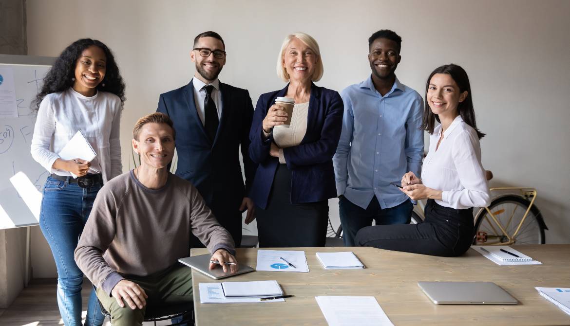 multiracial committee members posing together, smiling