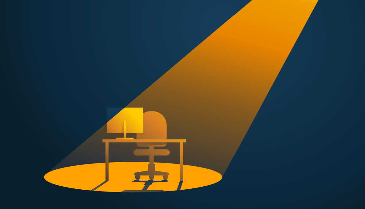 a spotlight shines on an empty desk