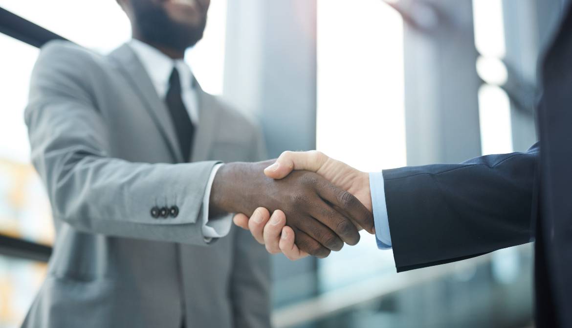 two businessmen shake hands