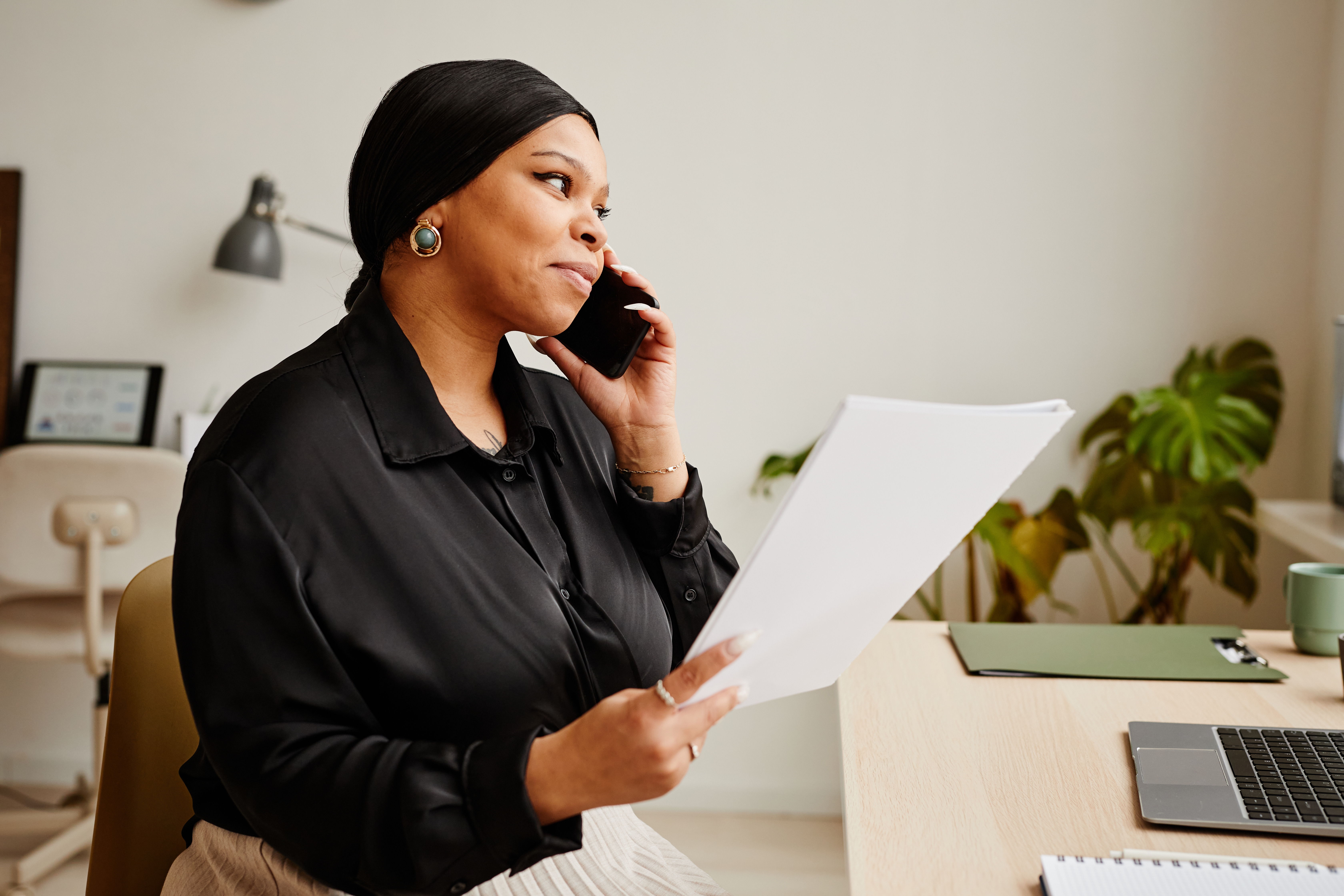 black woman using smartphone in office