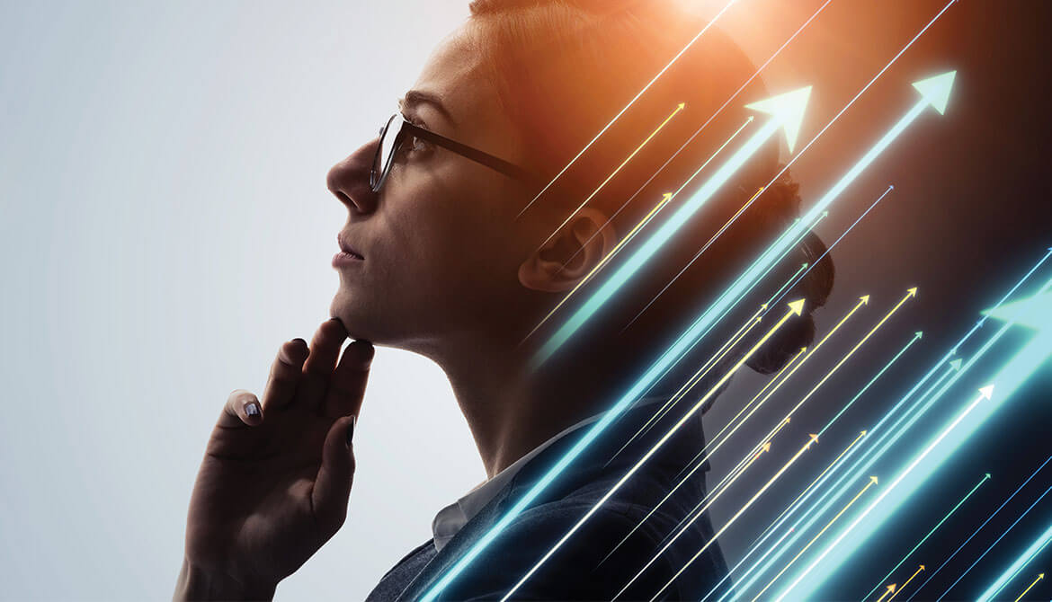 businesswoman in glasses holding chin while staring thoughtfully into space