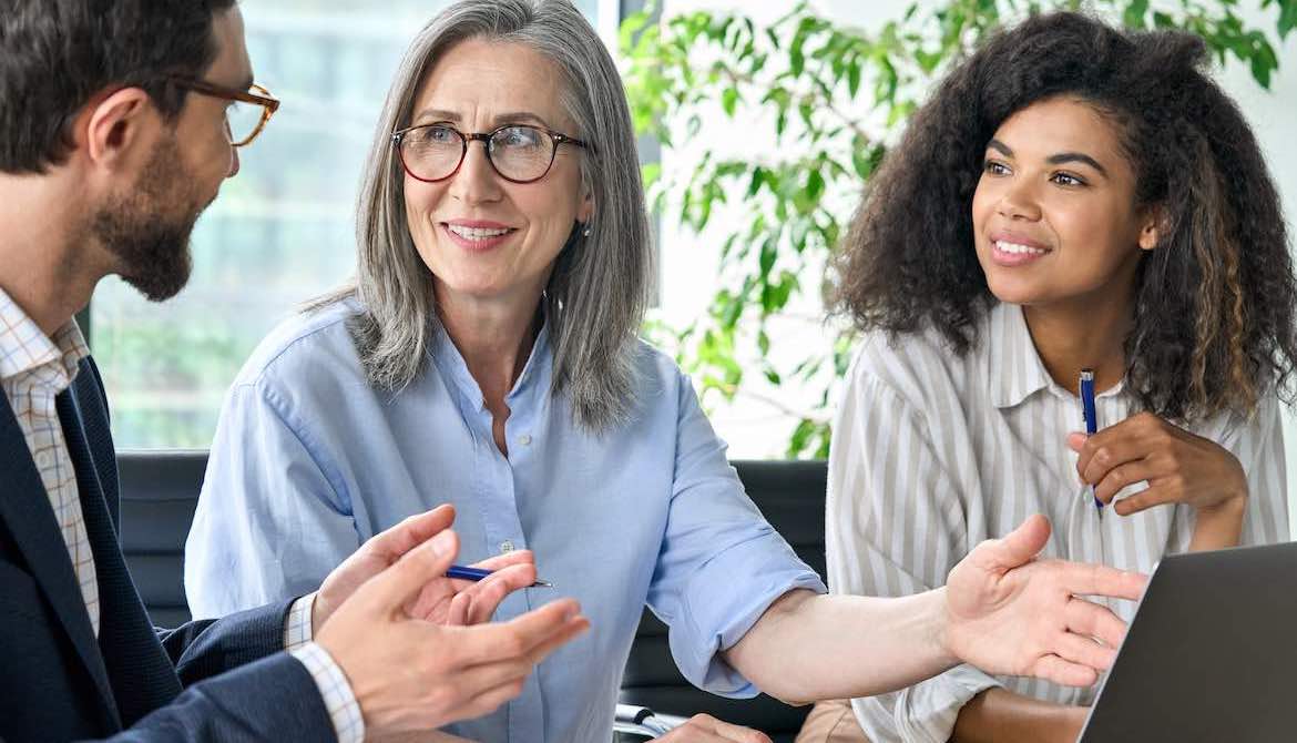 senior female executive sponsors younger BIPOC exec in a meeting