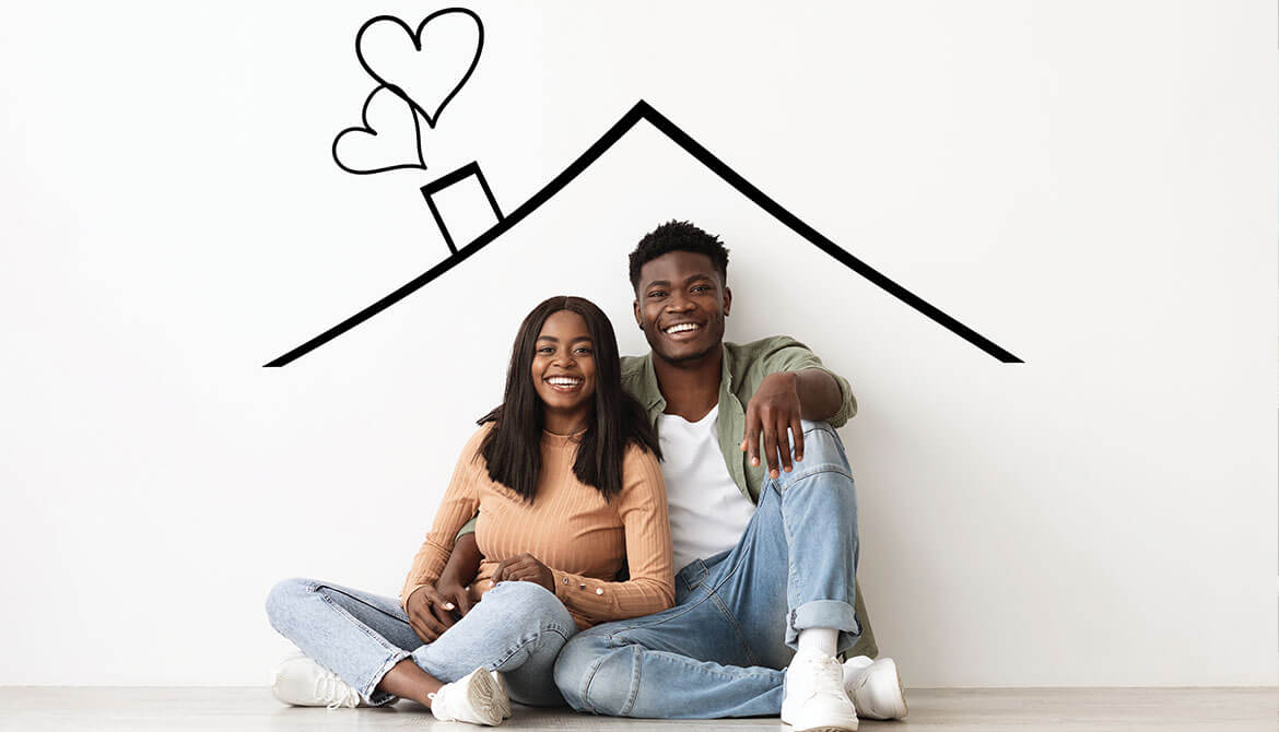 happy young Black couple sit under drawing of a house roof