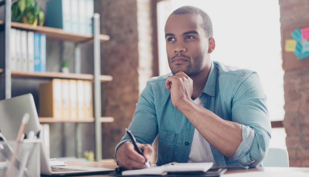 young business leader thinks about decision in work office