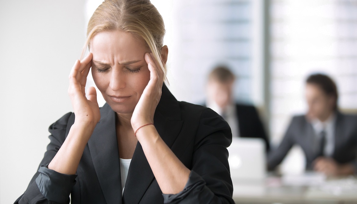 stressed young female business leader in the workplace