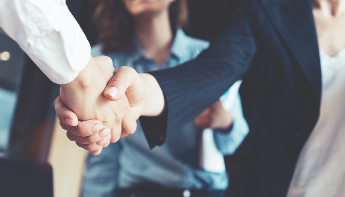 business people shaking hands to seal deal after successful negotiation