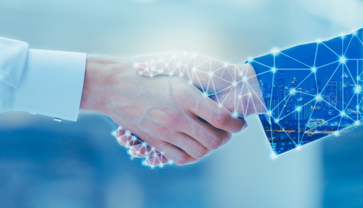 businessperson and technology vendor shaking hands to make deal
