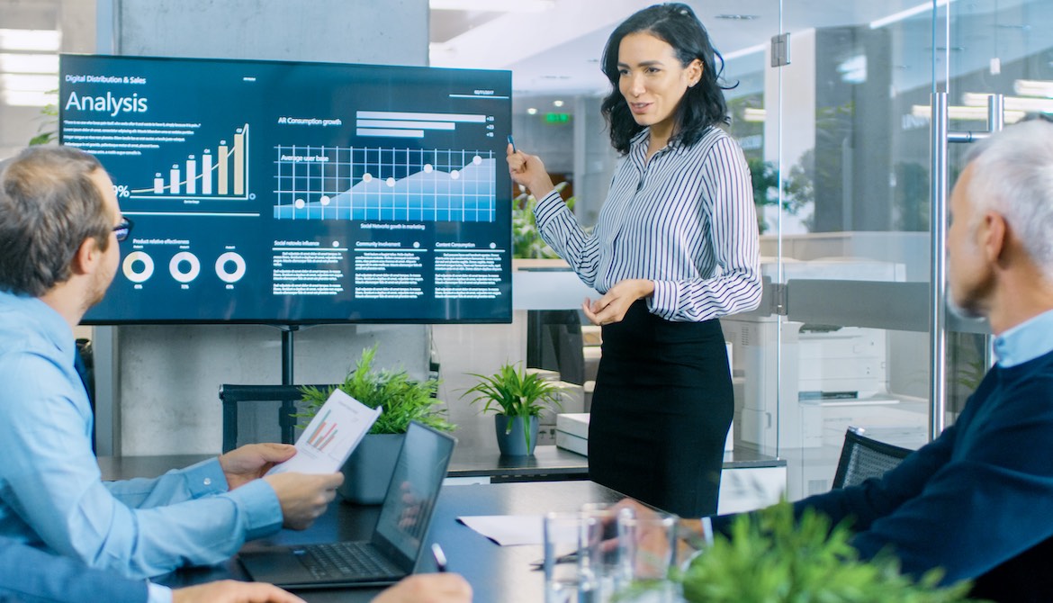 confident businesswoman gives presentation to executive team