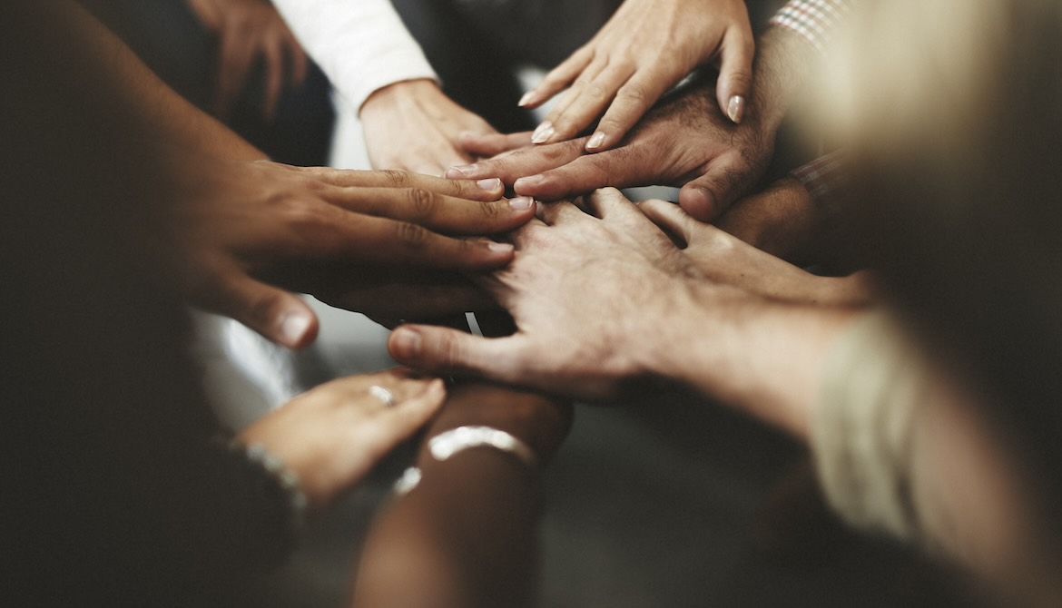 diverse hands together