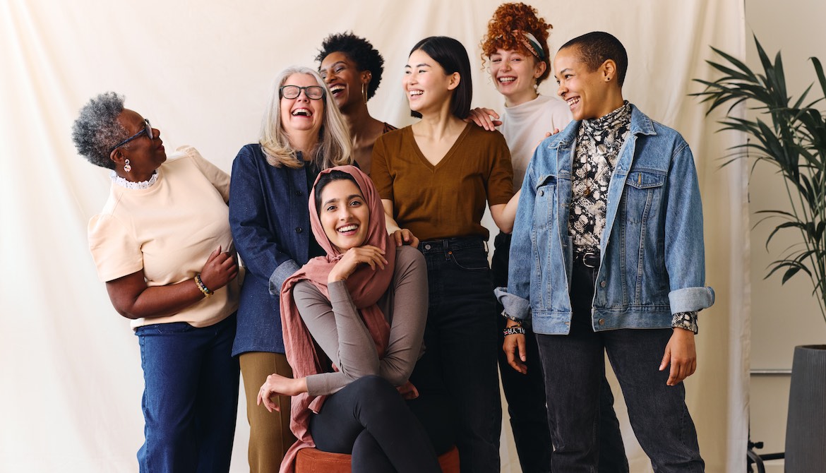 group of professional women take team photo together