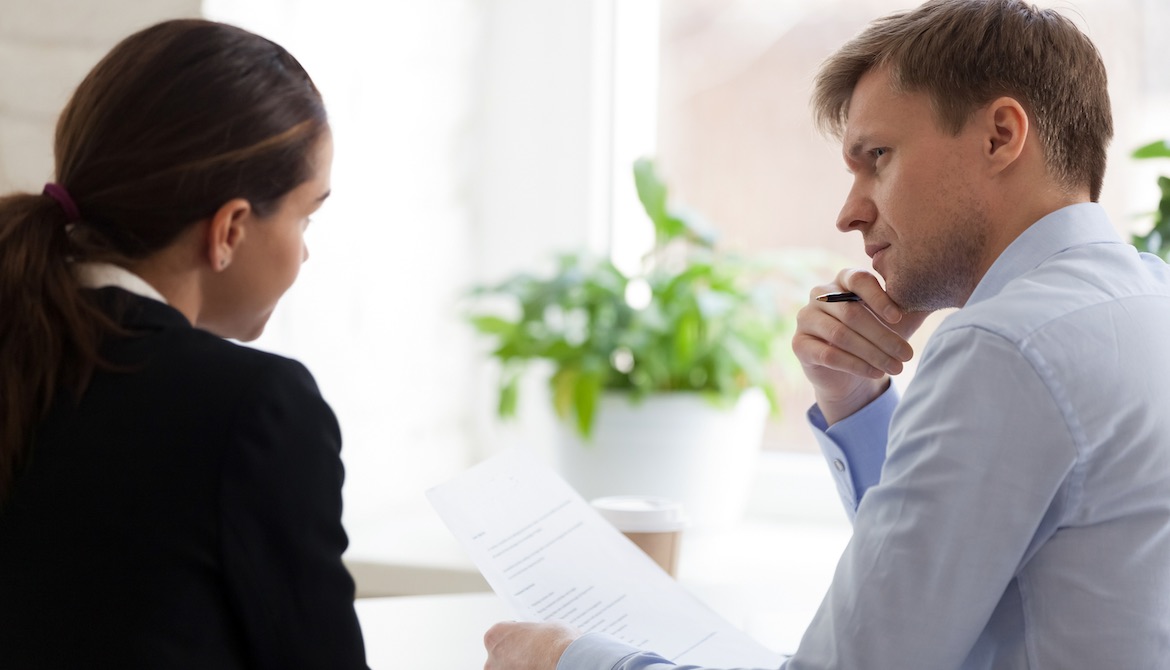 manager having tough conversation with employee at the office