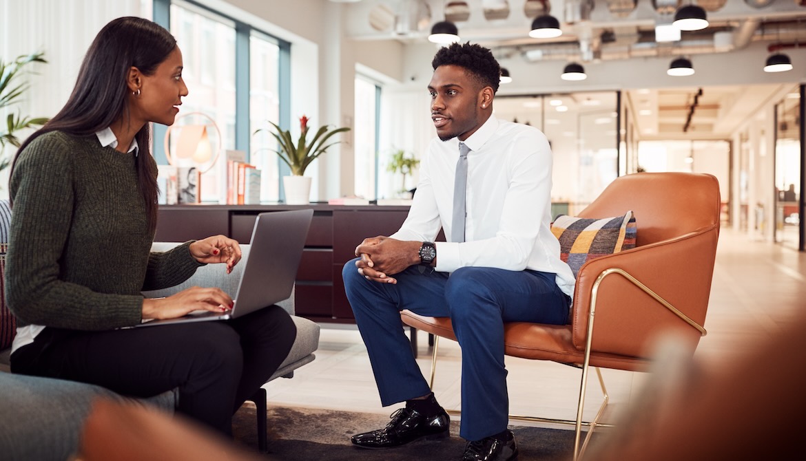 manager and employee having one-on-one meeting at the office