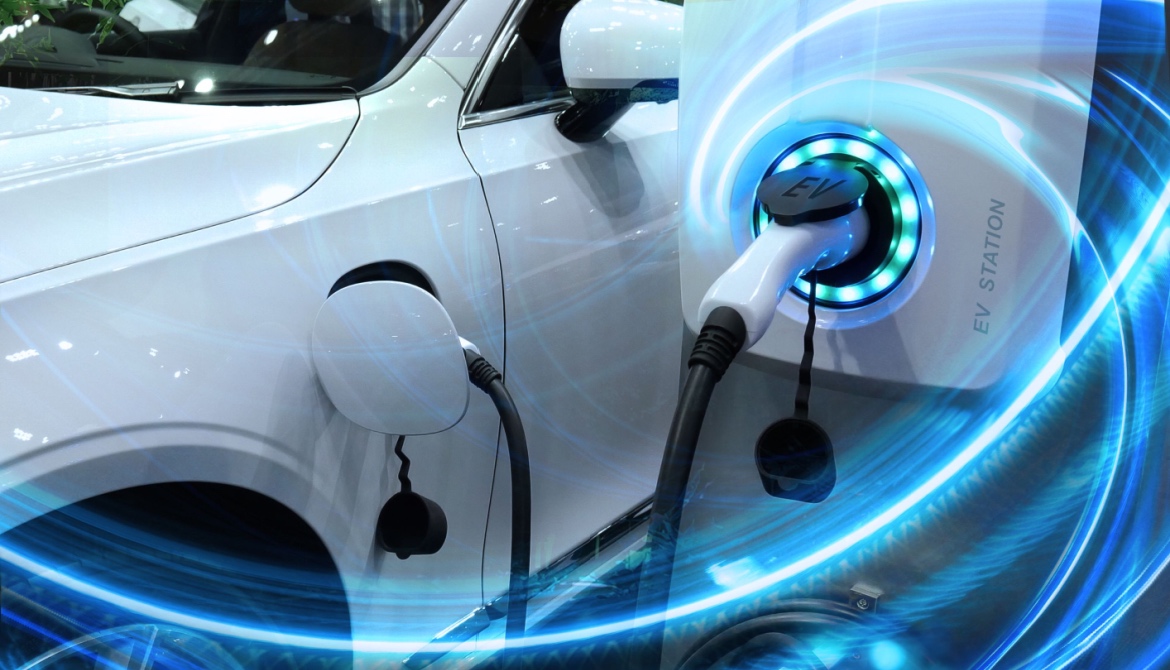 a white electric vehicle is plugged in and charging