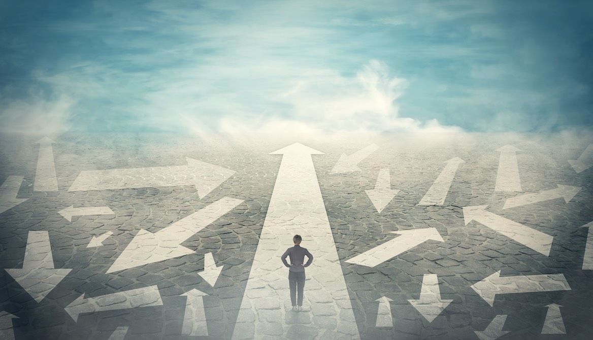 business woman looking at many arrows of possible career paths