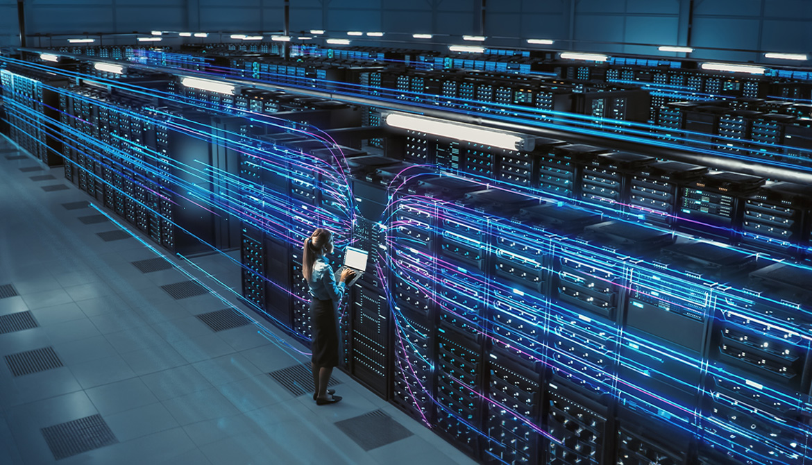 Woman standing in front of wall of computer servers