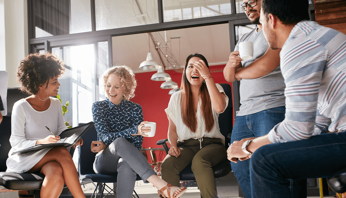 co-workers sitting in a circle laughing