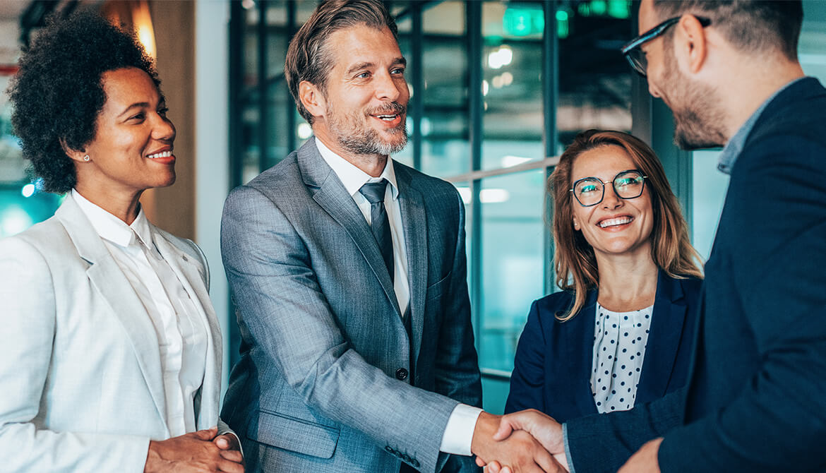 group of people with 2 gentlemen shaking hands