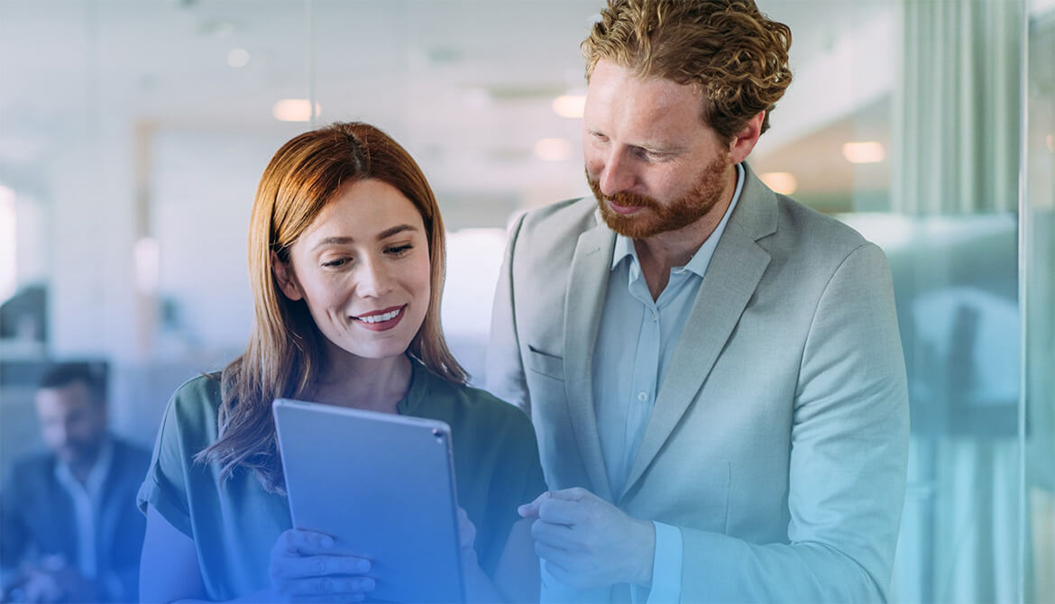 man and woman looking at a tablet