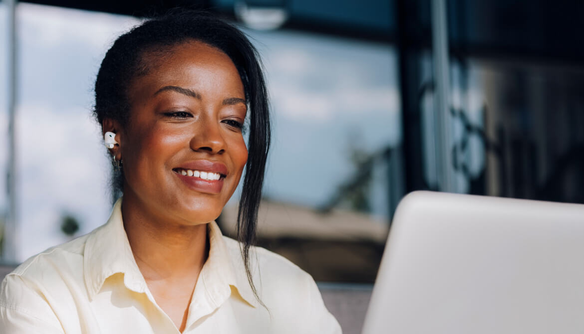 woman smiling at computer screen