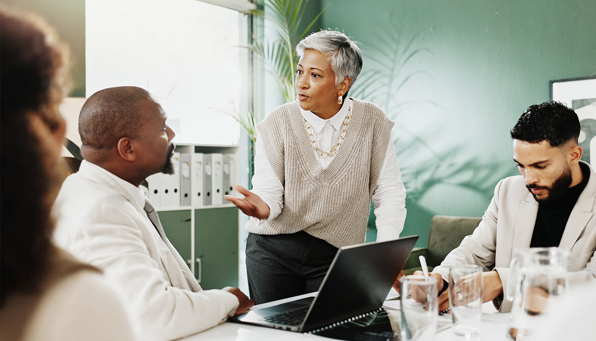 woman explaining to a man over a laptop