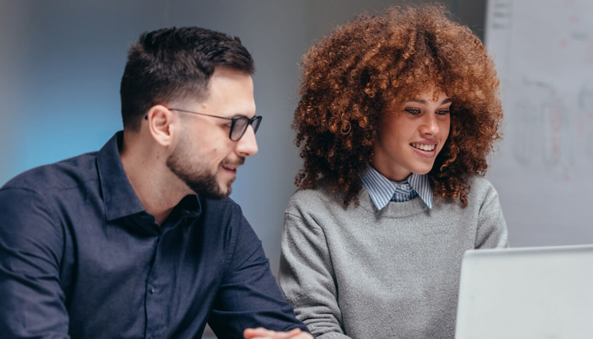 man and woman looking at laptop