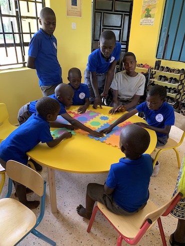 Don Bosco School students at table in uniforms