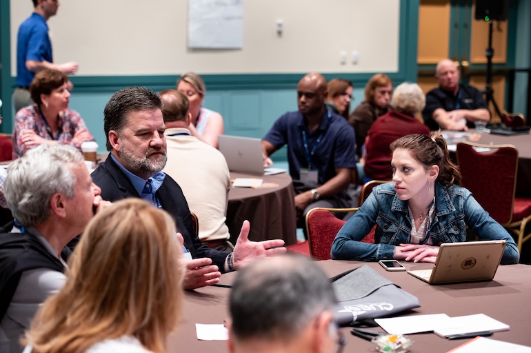 young director at conference table with other directors