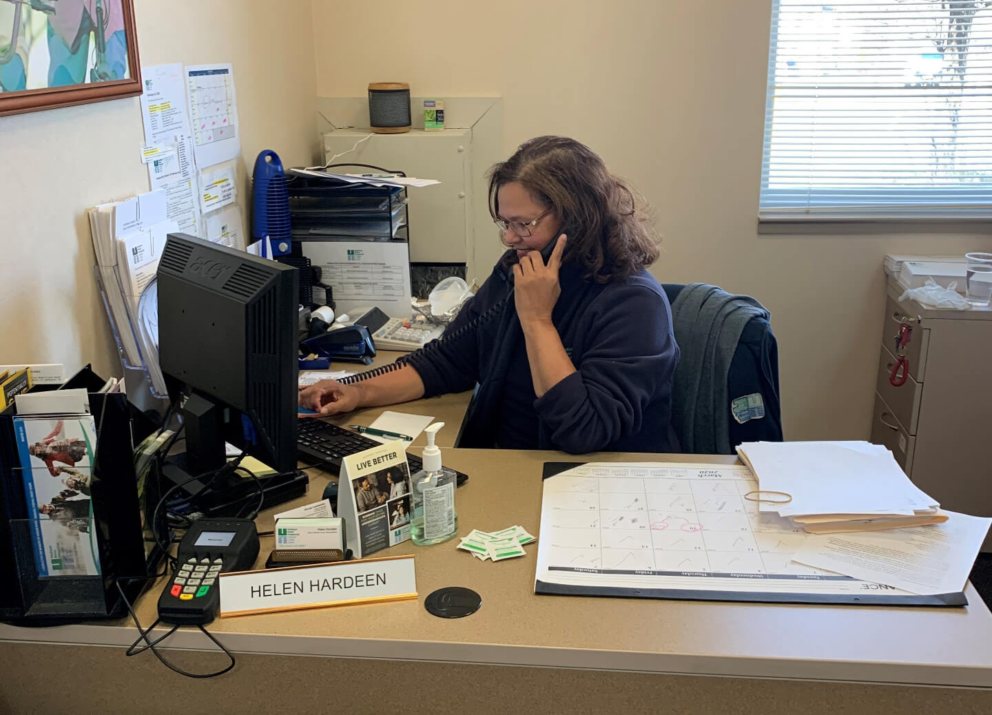 woman sitting at desk taking a call